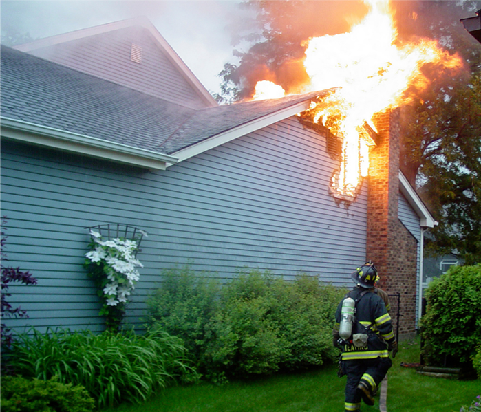 Fireman approaching house on fire